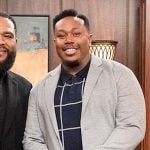 Marty's navy windowpane check polo shirt on The Neighborhood