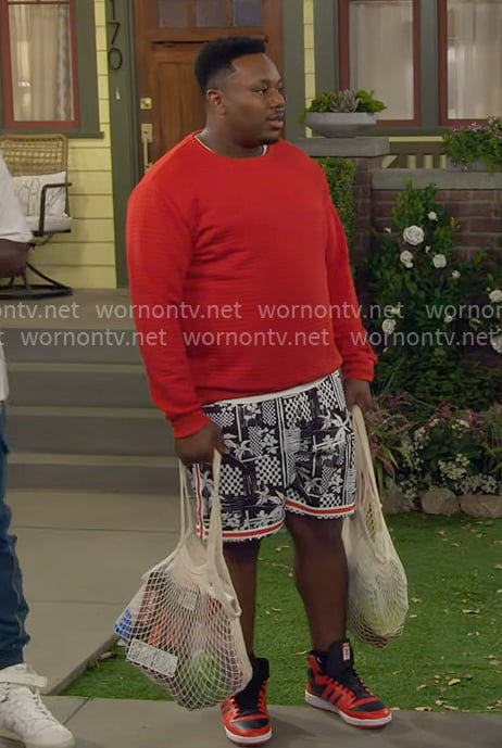 Marty’s red sweater and printed shorts on The Neighborhood