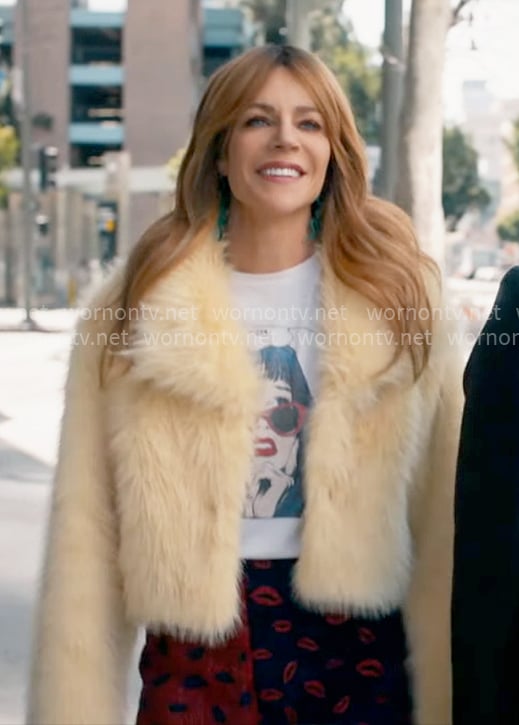 Morgan's graphic tee and yellow fur jacket on High Potential