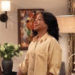 Tina's gold cropped shirt on The Neighborhood