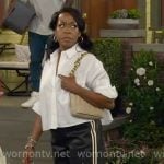 Tina’s white cropped shirt and faux leather track pants on The Neighborhood