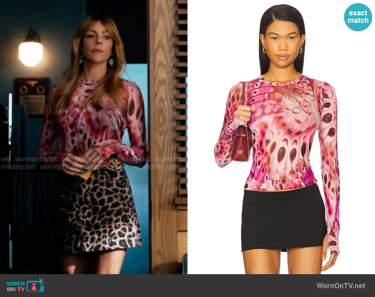 AFRM Kaylee Top in Berry Butterfly worn by Morgan Gillory (Kaitlin Olson) on High Potential