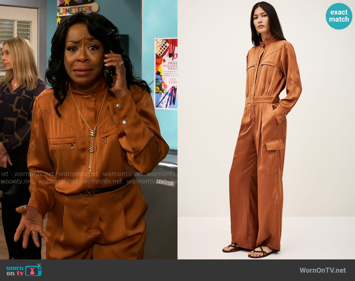 Tina’s orange cargo jumpsuit on The Neighborhood