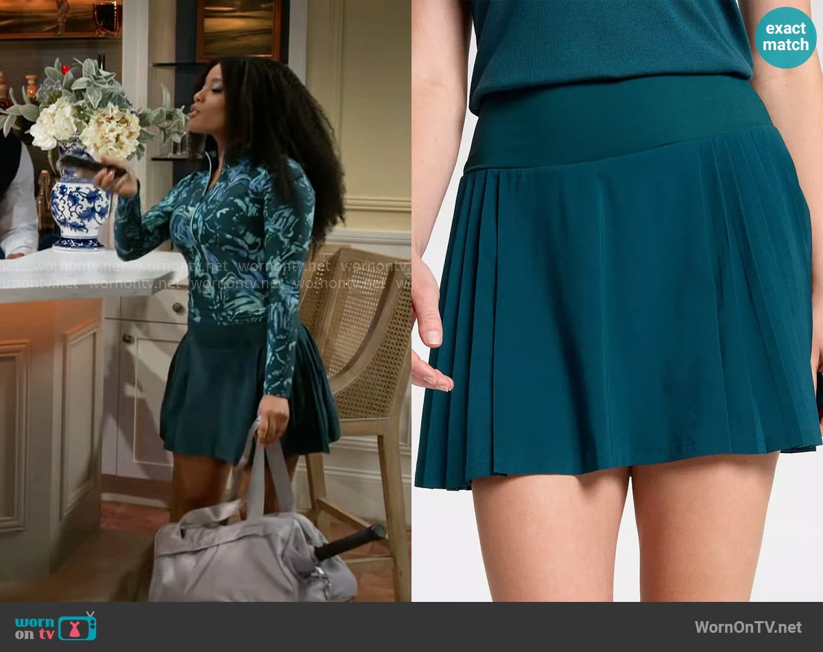 Eva’s teal pleated skirt on Beyond the Gates