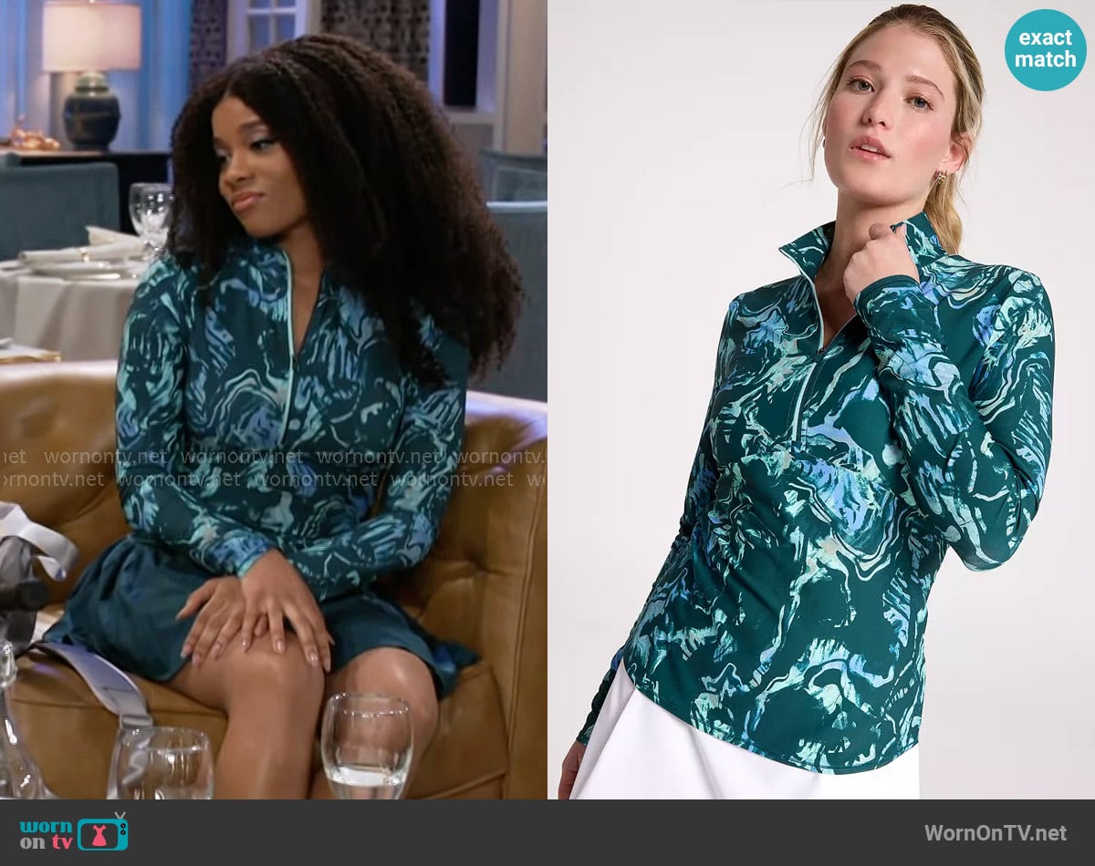Eva’s teal printed top on Beyond the Gates