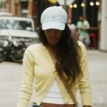 Ciara's yellow cardigan and cap on Summer House