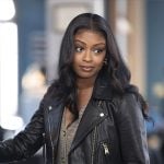 Daphne’s checked v-neck jumpsuit and leather jacket on High Potential