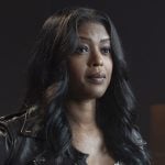 Daphne’s white scalloped top and brown leather jacket on High Potential