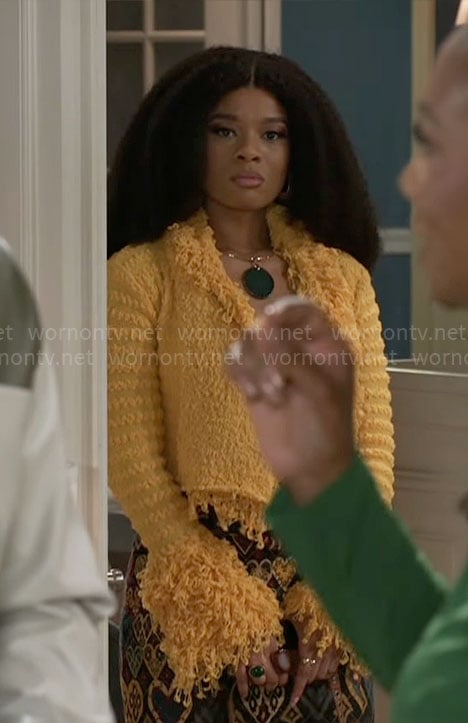Eva’s yellow fringed jacket and heart print skirt on Beyond the Gates