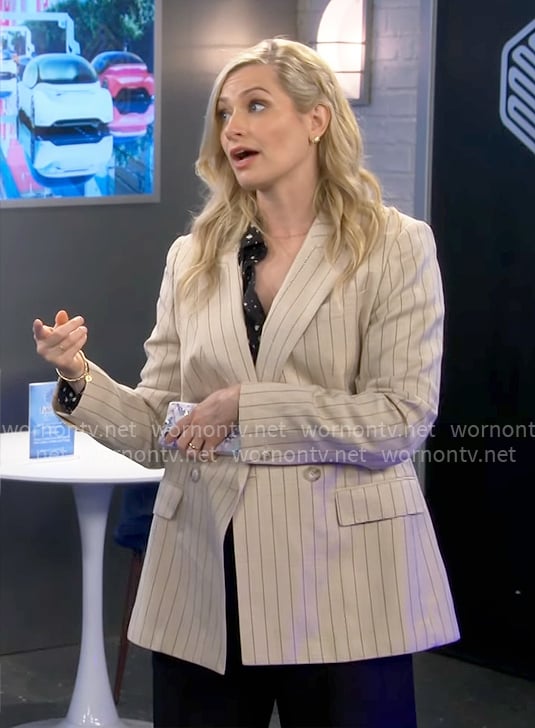 Gemma's black and white dotted shirt and beige pinstripe blazer on The Neighborhood