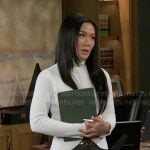 Caroline’s white zip jacket and turtleneck on Beyond the Gates