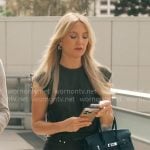 Isla's black draped dress with metal details on Running Point