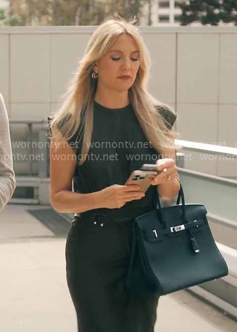 Isla's black draped dress with metal details on Running Point