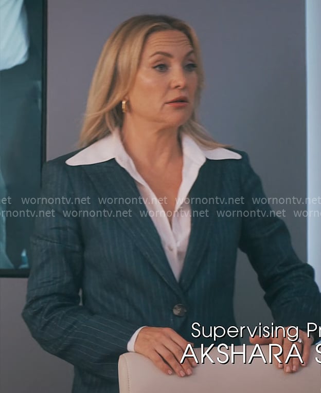 Isla's navy pinstripe suit on Running Point