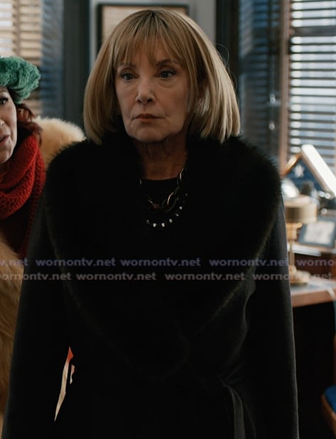 Izzy's black shearling collar coat on Elsbeth