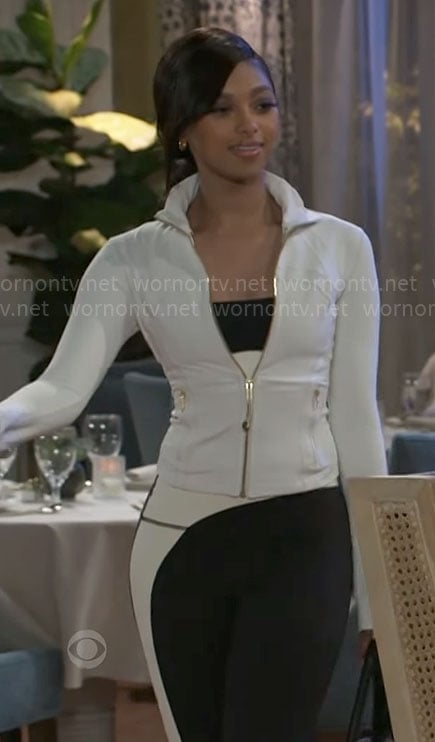 Kat’s white jacket with gold zip and two tone leggings on Beyond the Gates