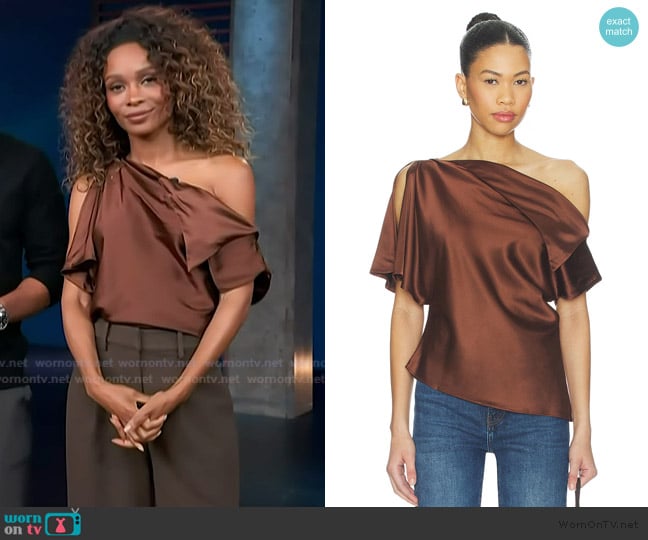 Zuri’s brown satin off shoulder top on Access Hollywood