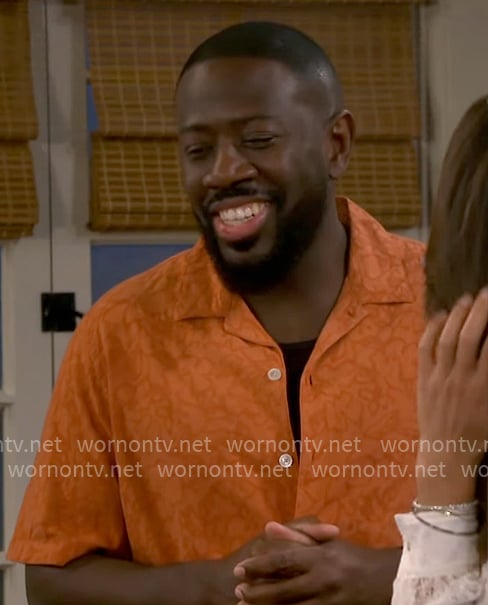 Malcolm's orange printed shirt on The Neighborhood