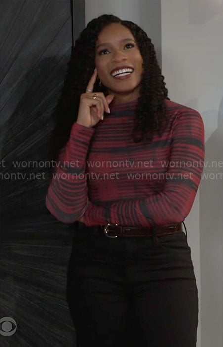 Naomi’s black and red striped top on Beyond the Gates