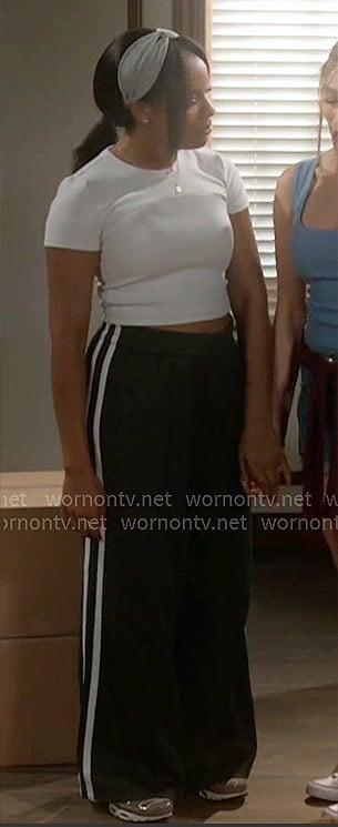 Naomi’s heathered tee and dark green track pants on Beyond the Gates