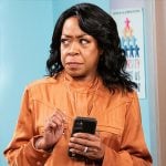 Tina's orange cargo jumpsuit on The Neighborhood