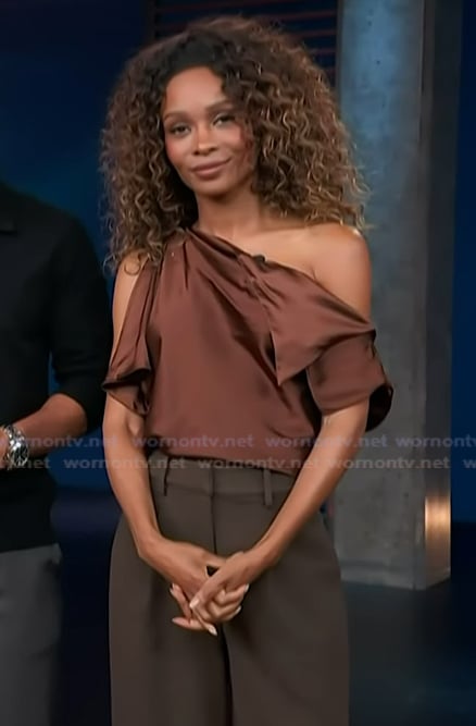 Zuri’s brown satin off shoulder top on Access Hollywood