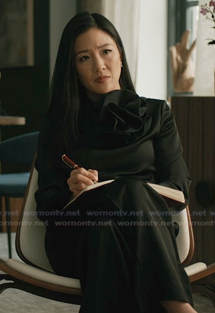 Mallory’s black ruffle neck blouse on Elsbeth